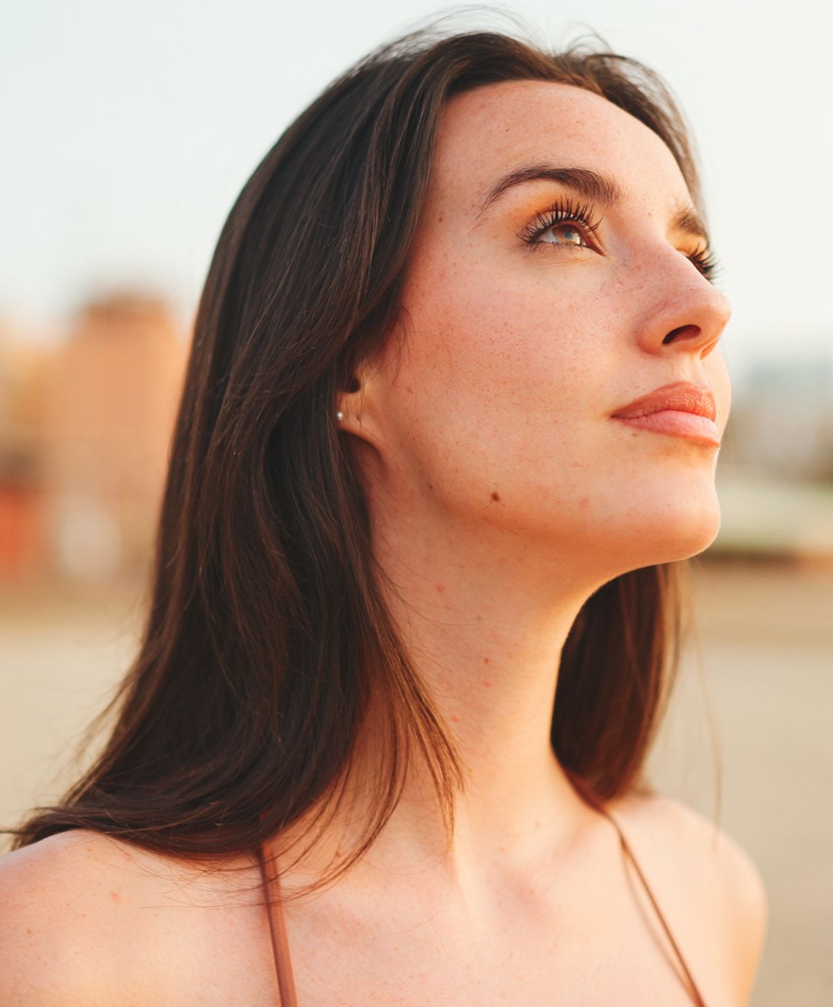 Woman gazing upward with a serene expression.