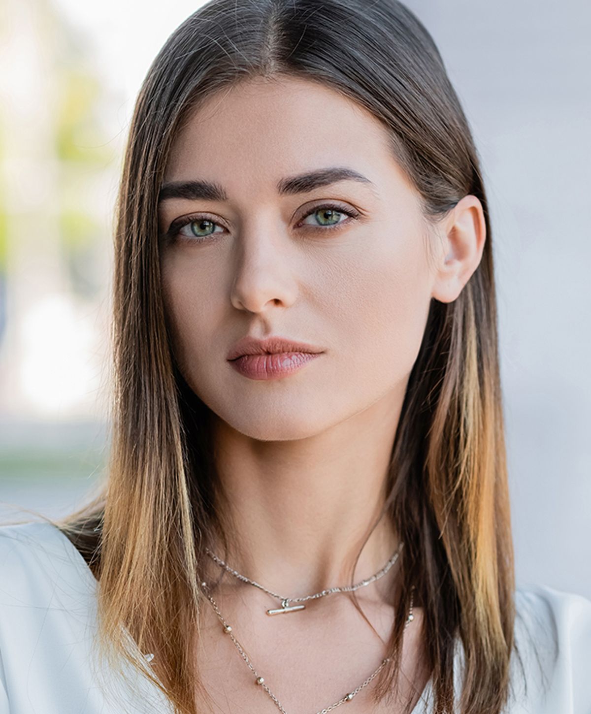 Young woman with medium-length hair and jewelry.