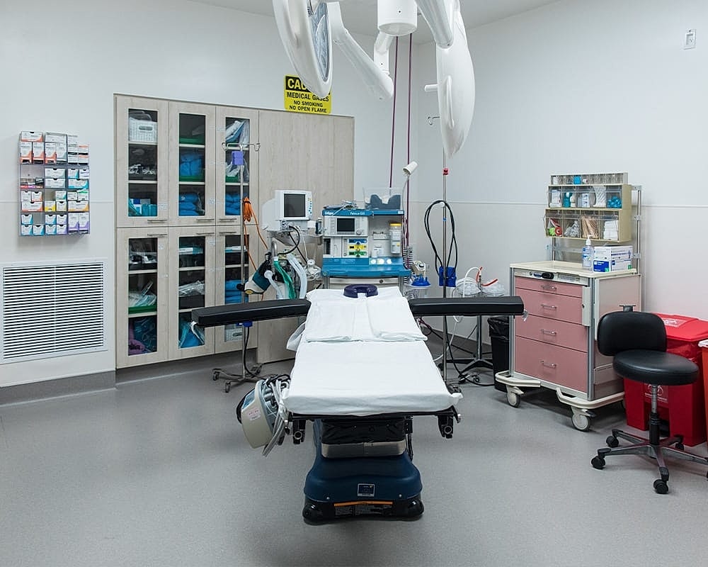 Medical examination room with equipment and supplies.