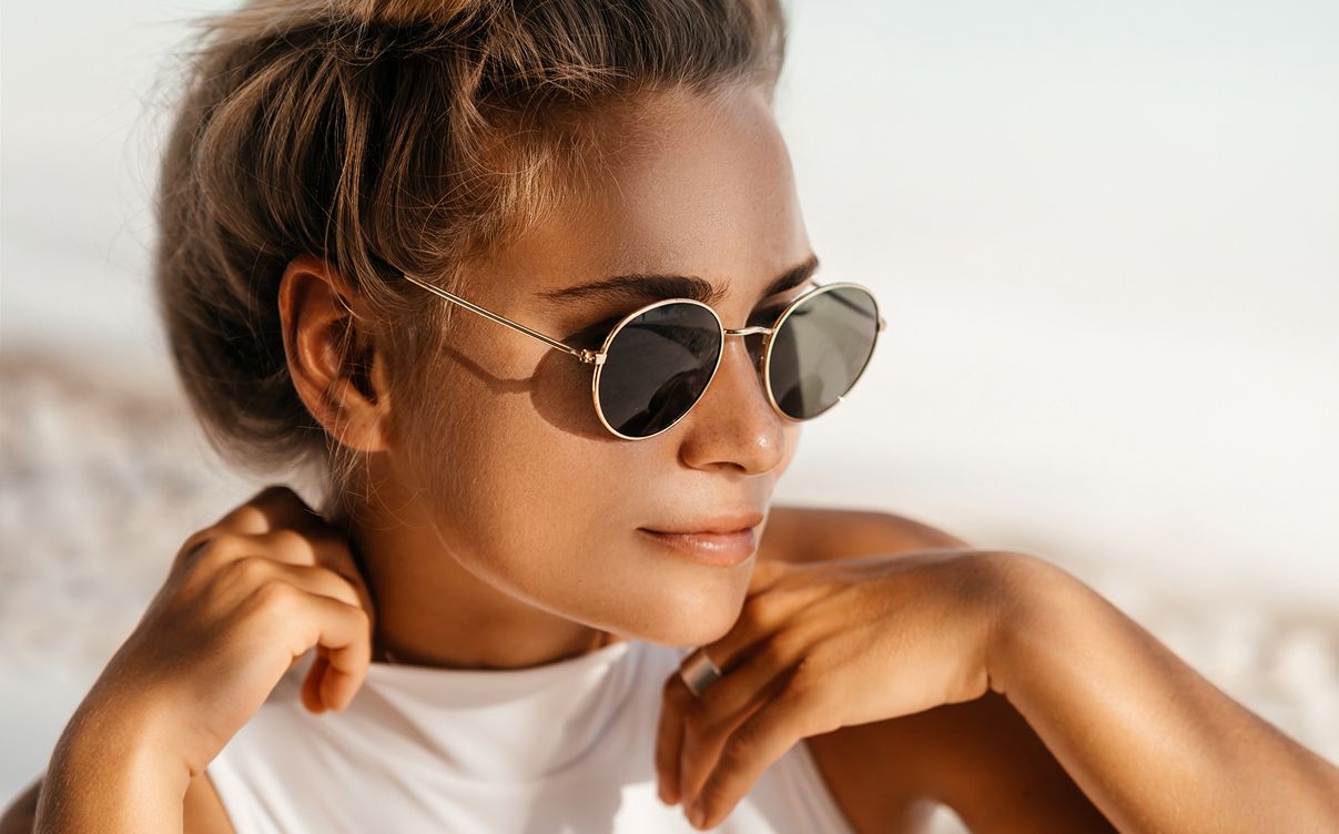 Woman in sunglasses enjoying sunny weather.
