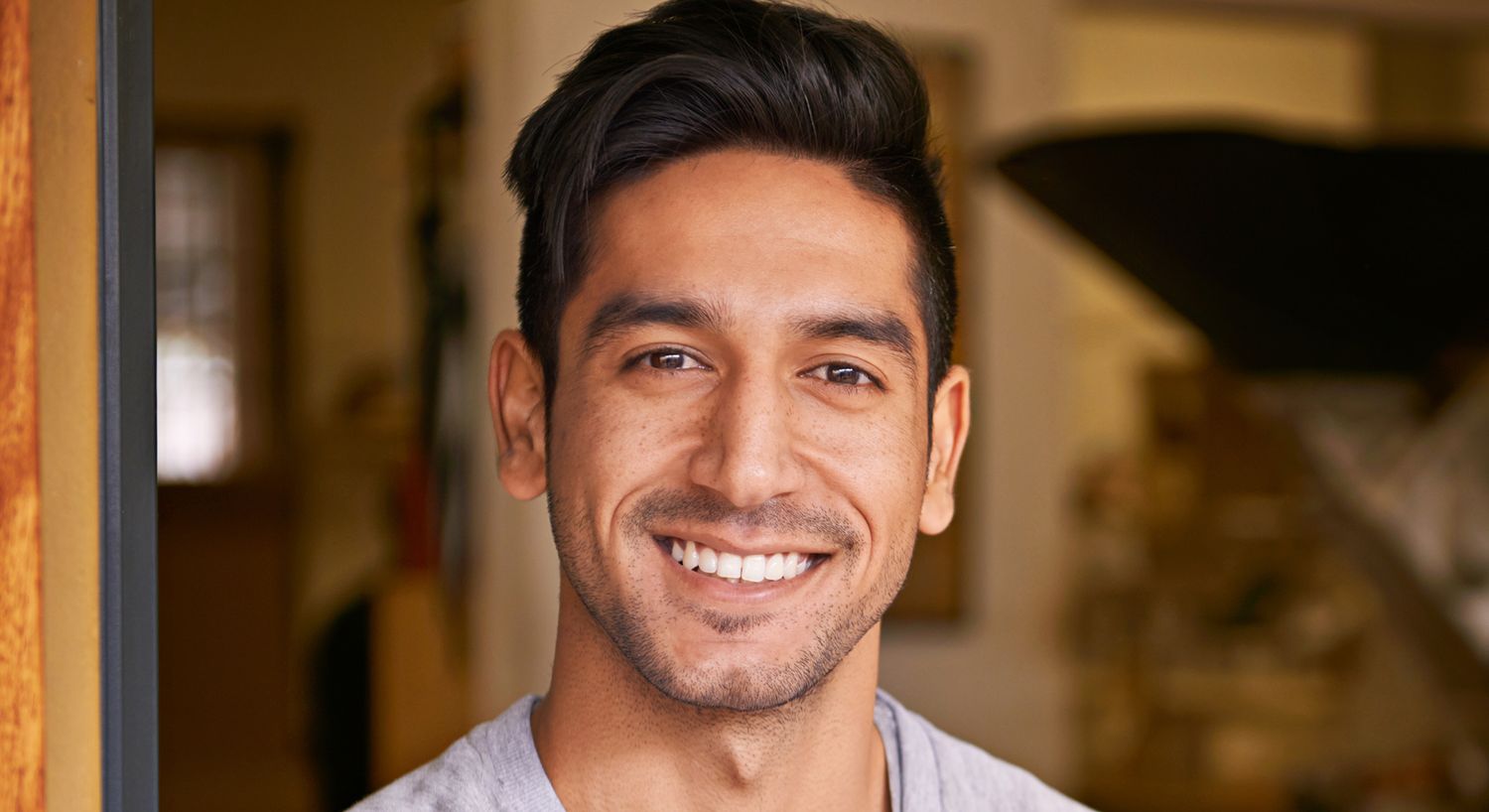 Smiling man standing in doorway.