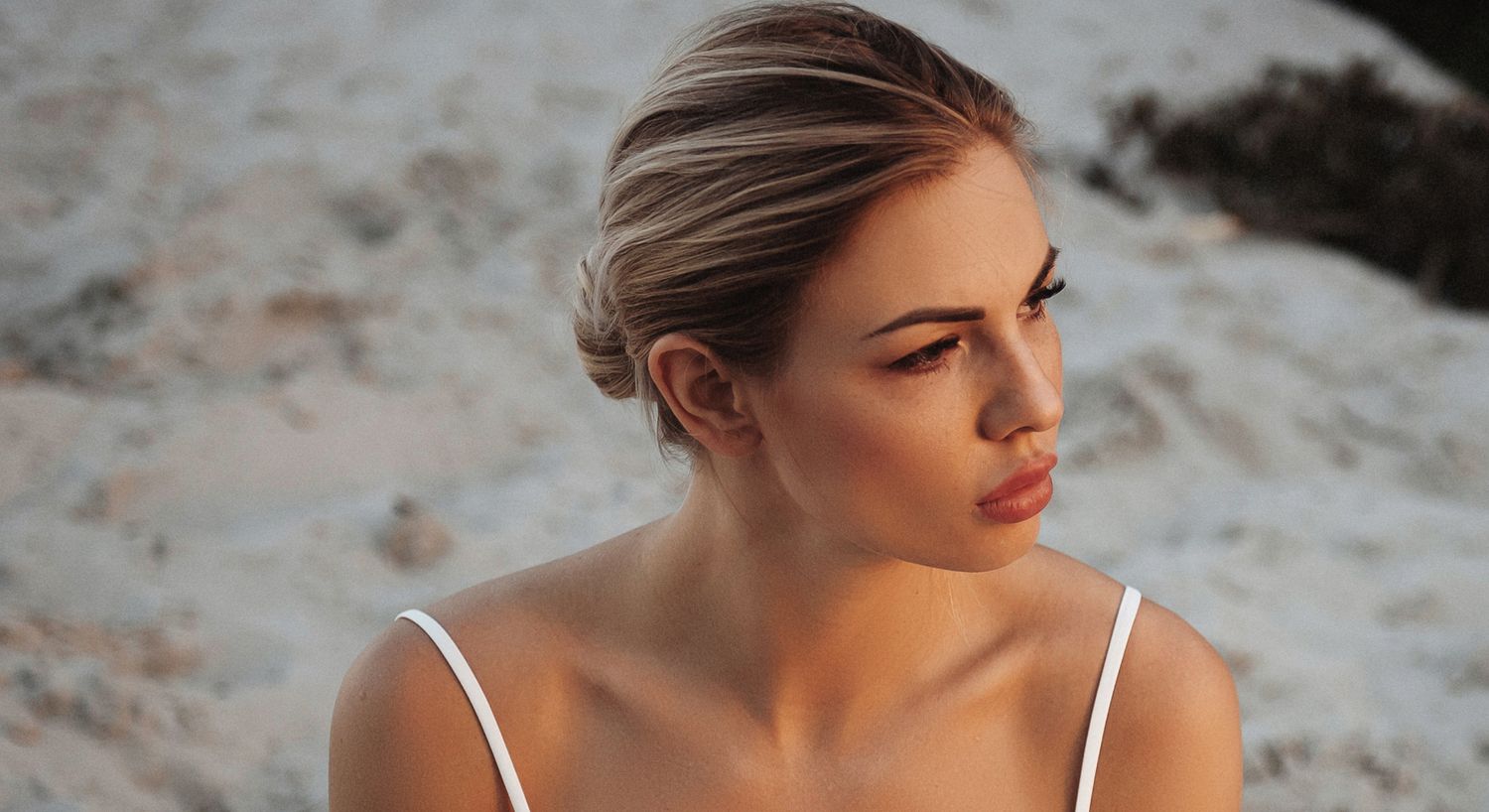 Woman with elegant hairstyle at the beach.