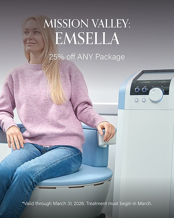 Woman seated next to Emsella treatment machine.